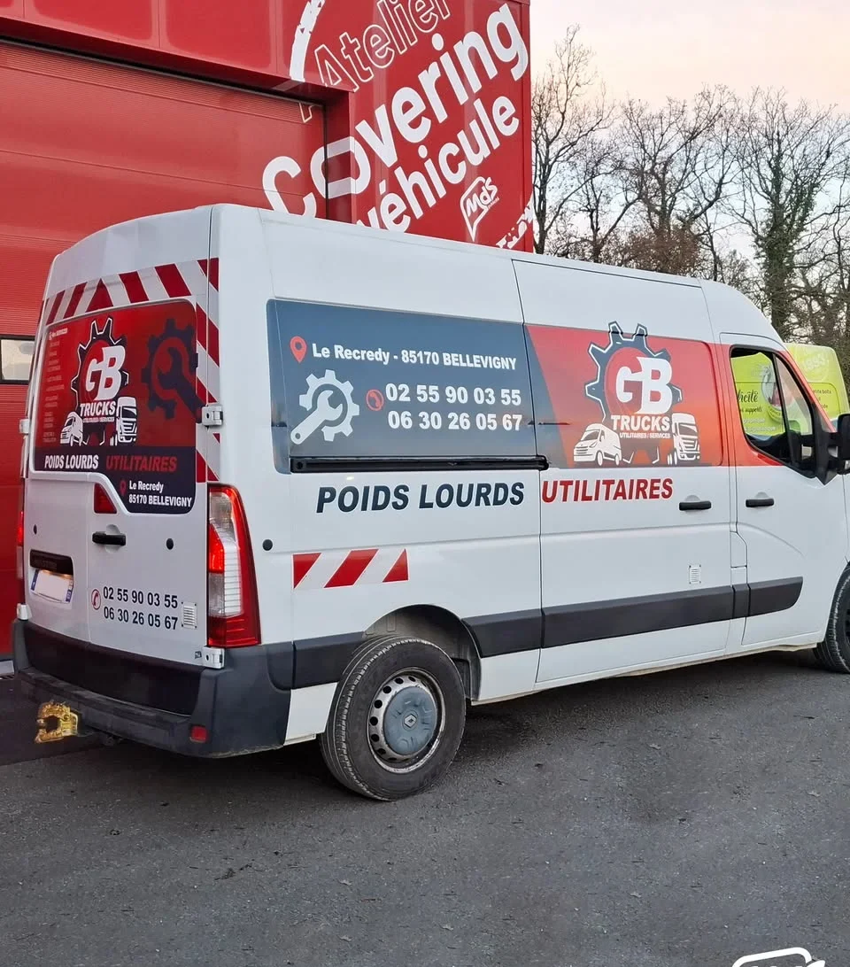 Utilitaire GB Trucks aux couleurs de l'atelier, avec les coordonnées de contact